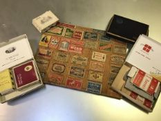 A panel with a collection of Swan Vesta and other matchbox covers, Abdulla Cigarettes etc. (a lot)