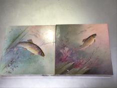 Two hand painted ceramic tiles by J.E. Dean, depicting a Trout and a Carp, signed (losses and