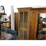 A 19thc stripped pine louvre panel door cupboard with adjustable shelved interior, on plinth base (