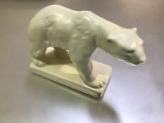 An English 1930s china model of a Polar Bear mounted on plinth base (h.16cm x 26cm x 10cm)