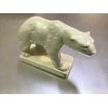 An English 1930s china model of a Polar Bear mounted on plinth base (h.16cm x 26cm x 10cm)