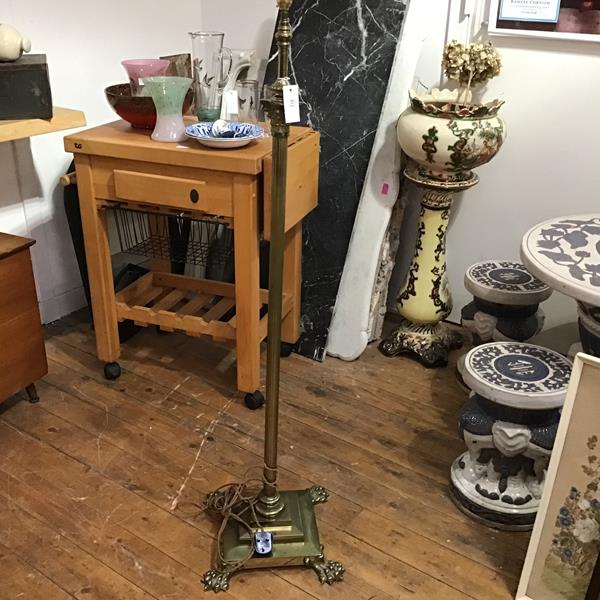 An Edwardian cast brass Corinthian column adjustable oil floor lamp, converted to electricity,