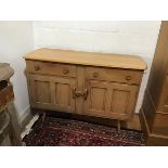 An Ercol light ash sideboard, the shaped top with moulded edge above two frieze drawers and two