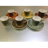 A Susie Cooper china eleven piece coffee set with stylised tree decoration in harlequin colours (