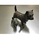 A Royal Doulton Cairn Terrier Grand Champion Charming Eyes, HN1033 and a smaller version, and a