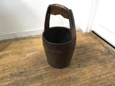 A Chinese hardwood bucket with carved loop handle with iron mounts (h.62cm x d. 33cm)