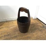 A Chinese hardwood bucket with carved loop handle with iron mounts (h.62cm x d. 33cm)