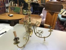 A 19thc brass fluted baluster column three branch centre light in the Victorian rococo taste, with