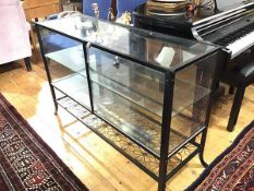 An anodised metal counter style display cabinet, with twin panel doors, and interior glass shelf and