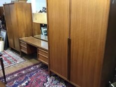 A teak 1960s three piece bedroom suite by Younger, comprising a lady's and gentleman's wardrobe, the