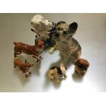 A collection of Royal Doulton china dog figures including Old English Sheepdog and Pup, two