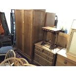 An oak two piece bedroom suite comprising wardrobe with twin inset panel doors and matching chest