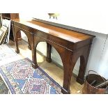 A yew wood hall table, the rectangular top with moulded edge with twin arched friezes, raised on