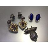 A pair of lapis white metal mounted oval rings, two white and yellow metal mounted pendants set