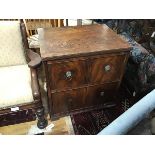 A 19thc mahogany dummy drawer front cabinet with fluted edge above a panel door, on plinth base (