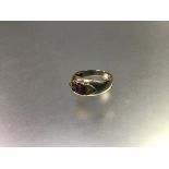 A 9ct gold three stone ring, the centre cushion cut amethyst flanked by triangular citrines, mounted
