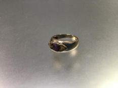 A 9ct gold three stone ring, the centre cushion cut amethyst flanked by triangular citrines, mounted