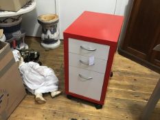 A modern red modular three drawer filing cabinet raised on castors (h.70cm x 37cm x50cm)