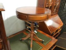 A yew wood drum style occasional table with circular top with crossbanded border, above an