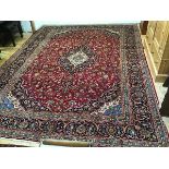 An Iranian Kashan fine hand knotted wool carpet, the central shaped medallion with lotus flower