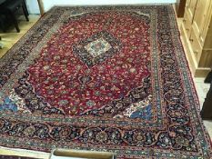 An Iranian Kashan fine hand knotted wool carpet, the central shaped medallion with lotus flower