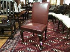 A George III style walnut framed library chair with upholstered ox-blood leather panel back and