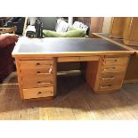 A 1940's oak pedestal desk by Abbess, the rectangular top with inset writing surface over a recess