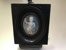 French School, late 18th century, a portrait miniature of an infant, oval, watercolour on ivory,