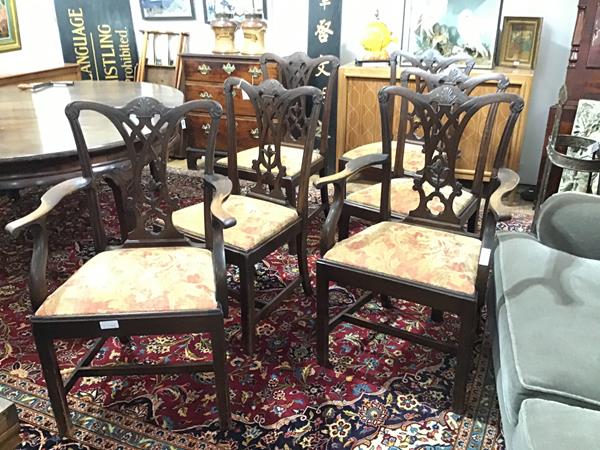 A set of six George III mahogany dining chairs, including two carvers, each with foliate carved