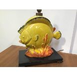 A 1950's novelty table lamp, modelled as a tropical fish amidst coral, in a yellow crackle glaze,