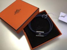 Hermes, a Tournis Tresse plaited leather bracelet, with palladium plated hardware, in original box.