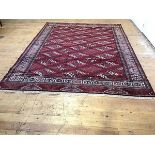 A Turkoman rug, the centre panel with three rows of diamonds, with running dog style borders,