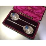 A cased pair of Edwardian silver seal-top serving spoons, Thomas Bradbury & Sons, London 1907, in