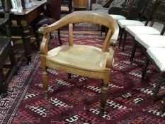 A 19th century oak horseshoe desk chair, the crest rail continuing to downswept arms flanking a