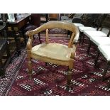 A 19th century oak horseshoe desk chair, the crest rail continuing to downswept arms flanking a