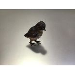 An Austrian cold-painted bronze model of a bird, c. 1900, probably a warbler, with yellow throat and