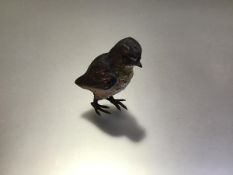 An Austrian cold-painted bronze model of a bird, c. 1900, probably a warbler, with yellow throat and