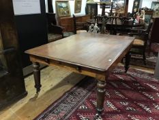 A Victorian mahogany library table, the rectangular top with rounded corners above a plain apron