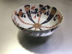 A Chinese porcelain Imari bowl, fluted, decorated with radiating vertical bands of flowerheads to