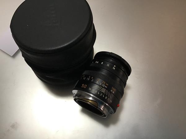 A Leica 50mm F2 Summicron-M lens, in a soft carry case
