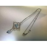 An Edwardian diamond and aquamarine pendant, claw-set to the centre with an oval-cut aquamarine