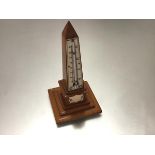 A 19th century ivory-mounted obelisk form treen desk thermometer, with stepped base. Height 16.5cm