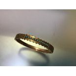 A 9ct gold hinged bangle set with turquoise and seed pearls, c. 1900, the front with a line of