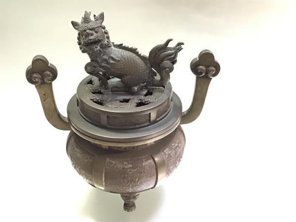 A Chinese bronze censer, of circular bellied form, the cover mounted with a kylin finial, the body