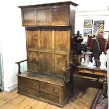 A handsome George III joined oak combination cupboard and settle or "Bacon Settle", c. 1760, with
