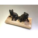 A 19th century parcel-gilt patinated metal or bronze group of two seated bull dogs, probably French,