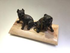 A 19th century parcel-gilt patinated metal or bronze group of two seated bull dogs, probably French,