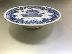 A blue and white faience tazza, 18th century, possibly Rouen, the circular dish painted to the