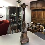 A 19th century parcel-gilt copper floorstanding altar candlestick, in Baroque style, with tapering