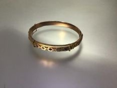 A late Victorian diamond and ruby-set gold bangle, in 9ct gold hallmarked for Birmingham 1898,